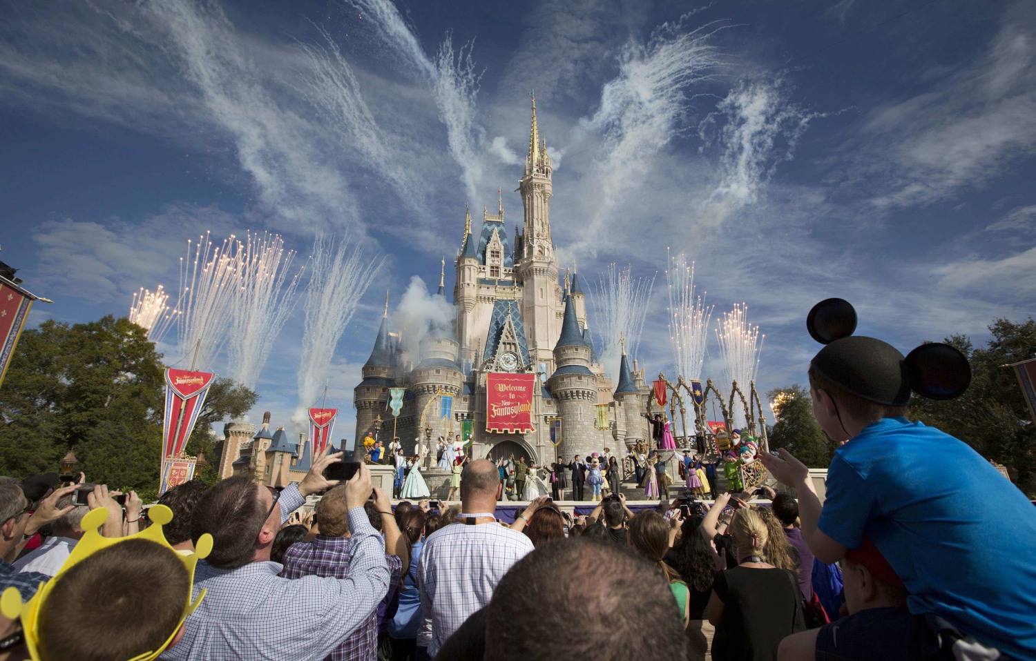 Guests Look on as Flames Shoot From Disney Castle