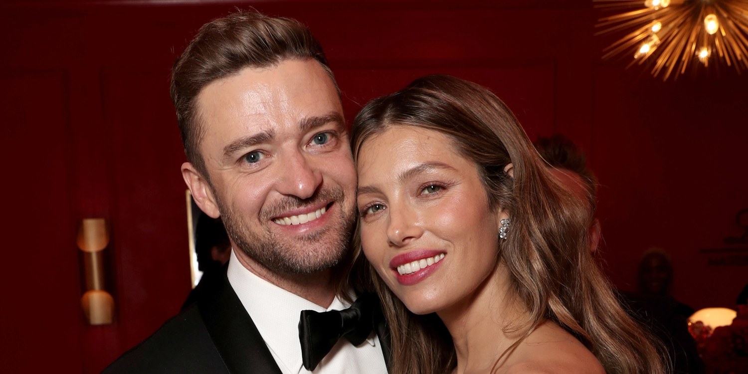 Justin Timberlake cradles son Silas as he and Jessica Biel board