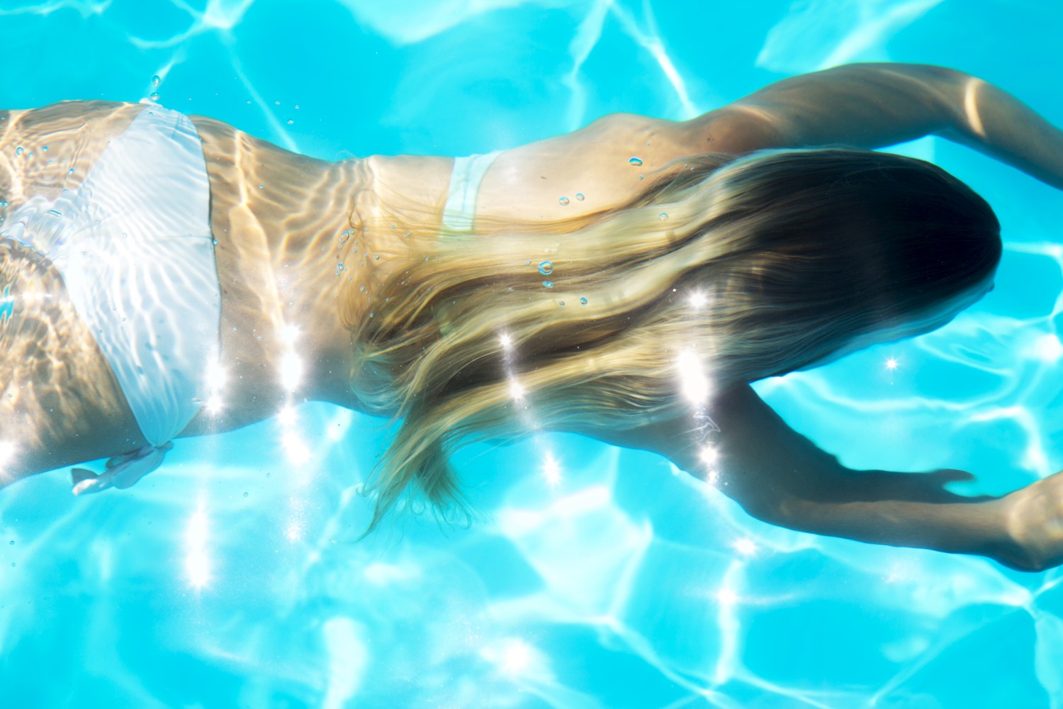 Underwater woman portrait with pink bikini in swimming pool Stock Photo