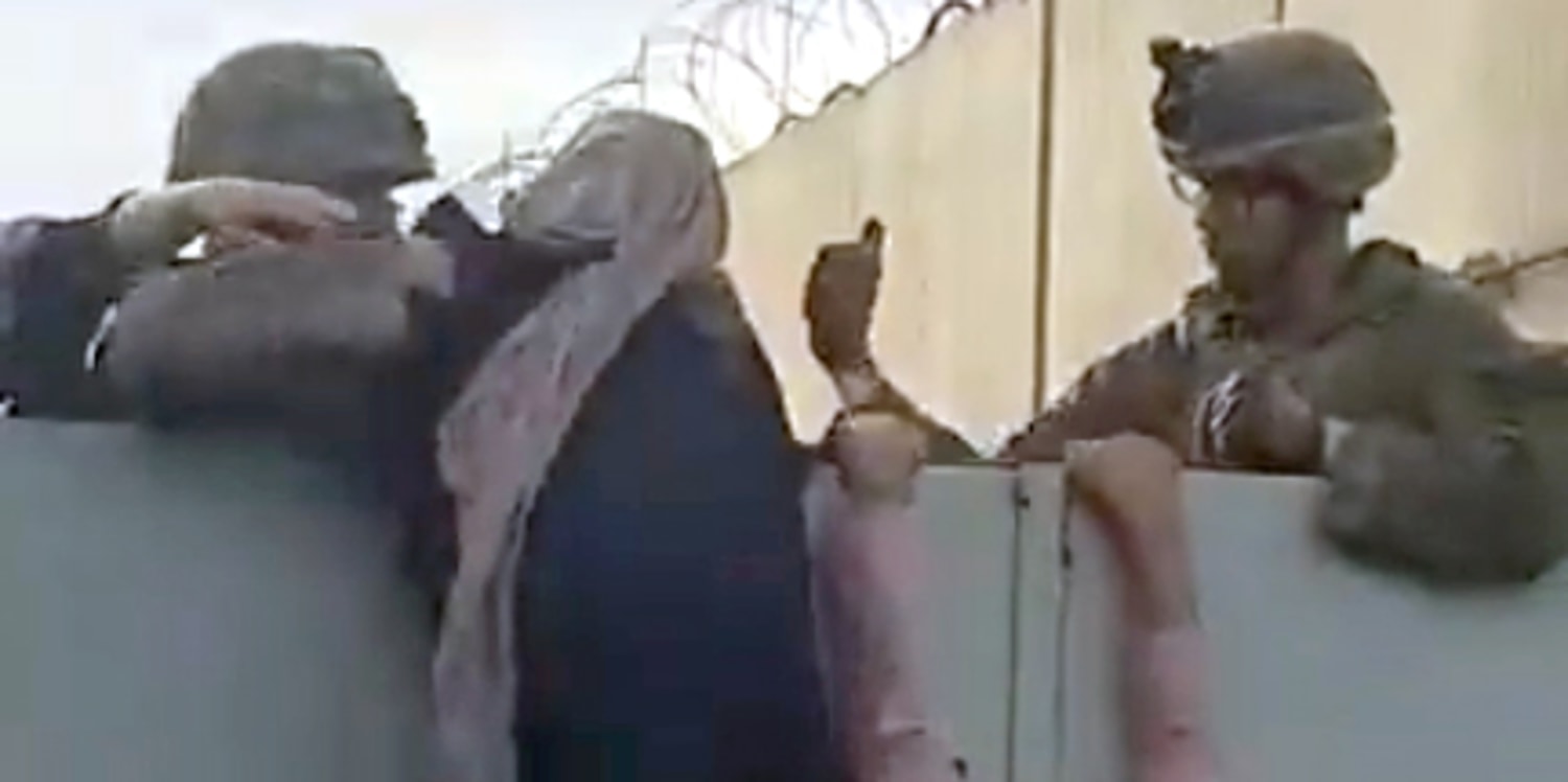 Videos show American soldiers help woman, child over wall at Kabul airport