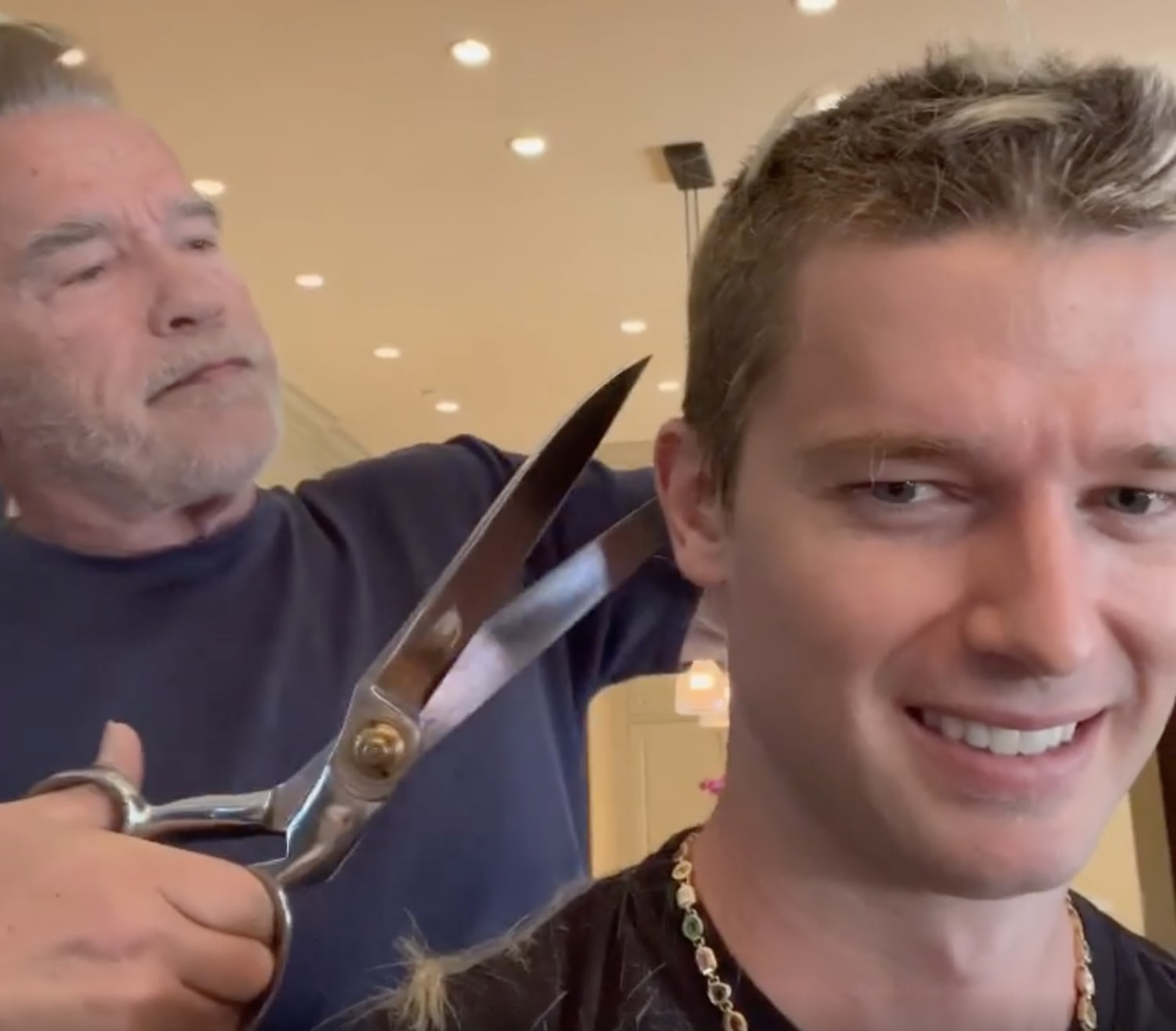 Arnold Schwarzenegger uses giant scissors to get son Patrick ready for a  date