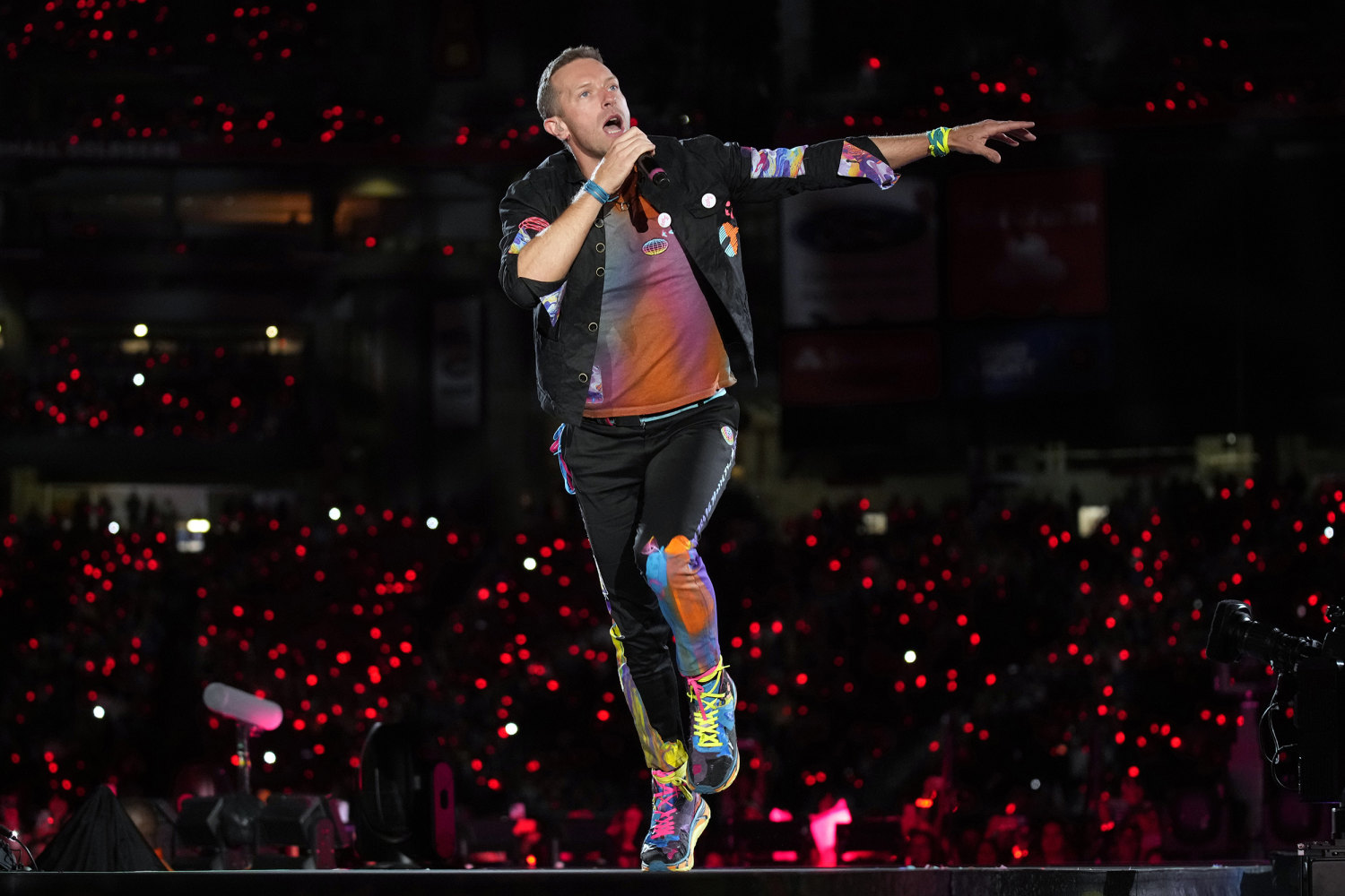 Coldplay front man Chris Martin leaps above the stage to perform