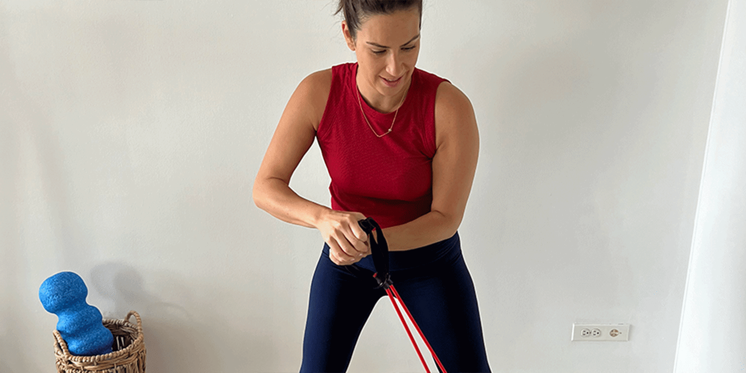 Woman doing woodchoppers exercise with resistance band