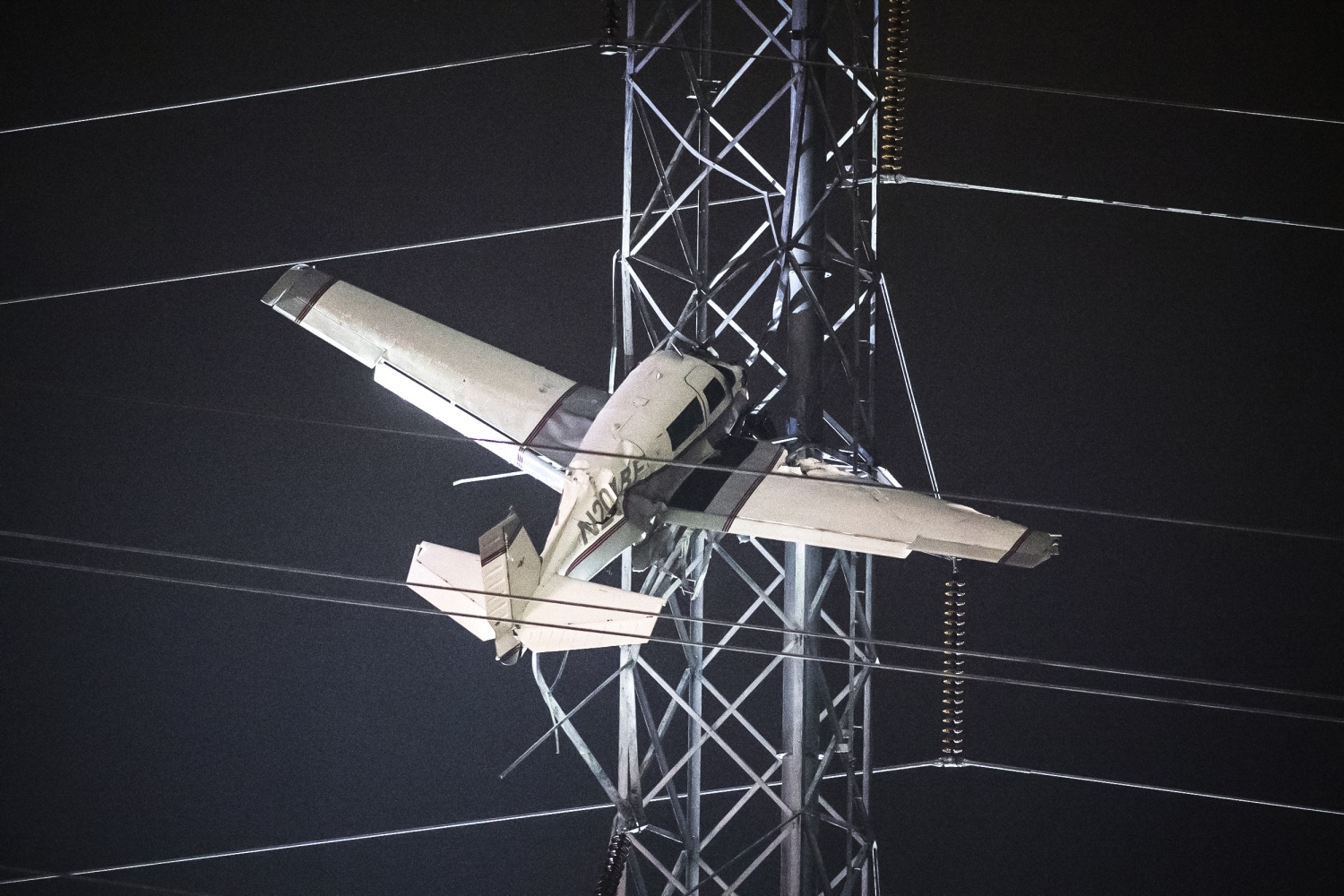 A small plane with 2 aboard dangles on Maryland power tower