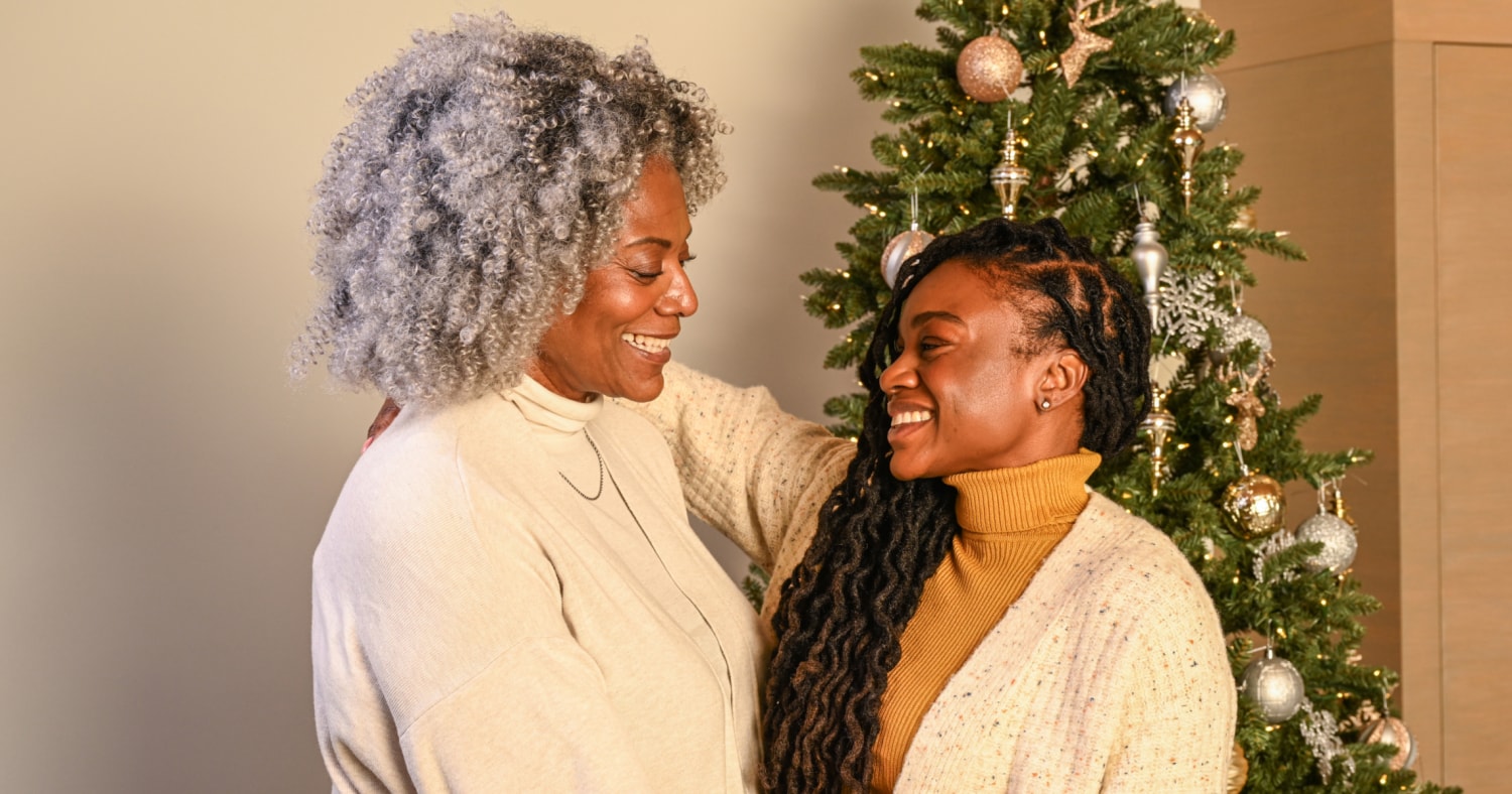 Premium Photo  Merry christmas and happy holidays! senior mom and her adult  daughter exchanging gifts. having fun near tree indoors. loving family with  presents in room.