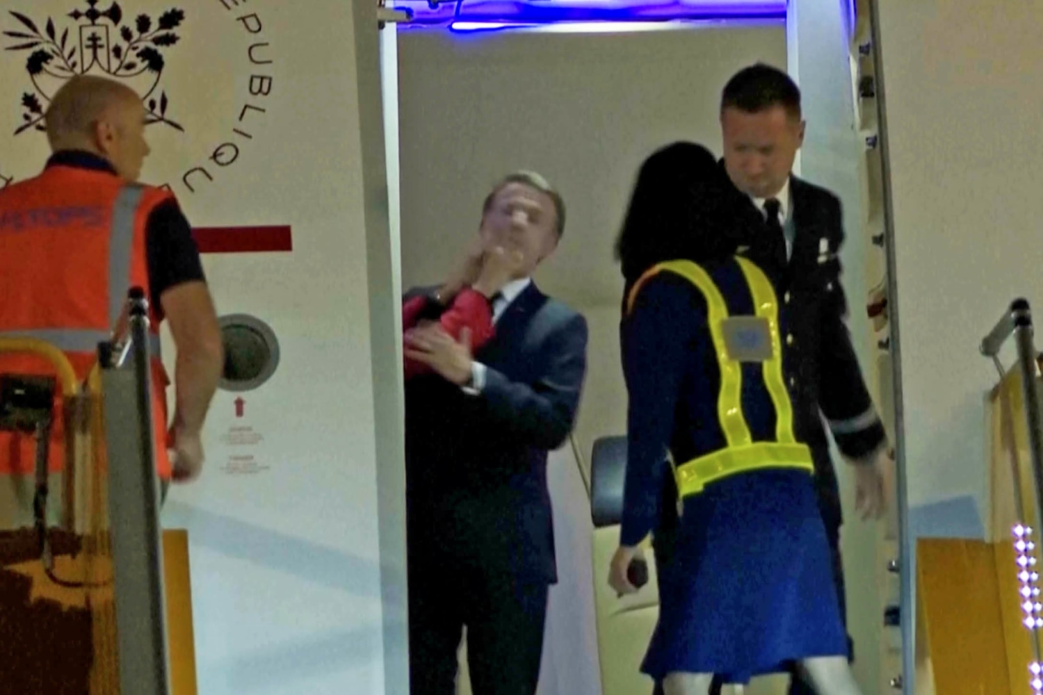 French president,  Emmanuel Macron addresses his wife shoving him in the face on aircraft
