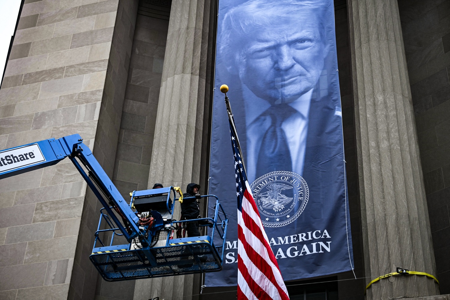 Large banner of Trump unfurled at Justice Department headquarters