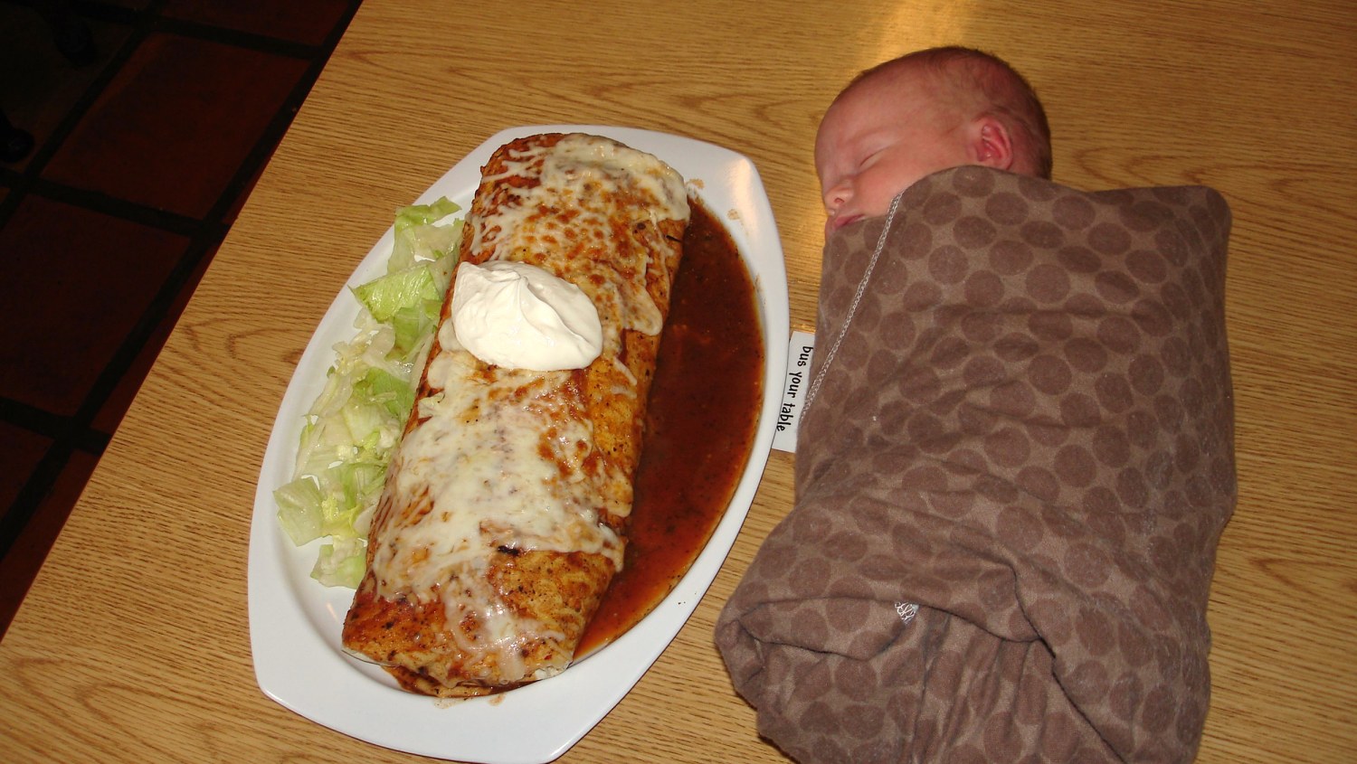 Size them up Babies pose next to monstrous burritos