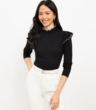 a woman wearing a black ruffle top