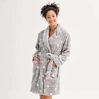 woman wearing a gray robe with white polka dots