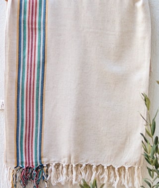 Photo of the Anatolico Sugar towel of white and colorful stripes hanging