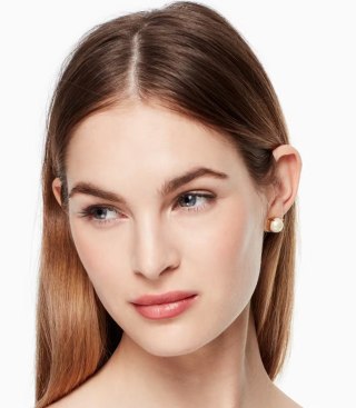 Model wearing pearl earrings