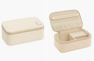 cream jewelry box with letter L on the lid, on a white background.