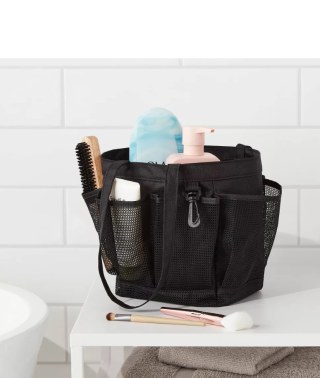Room Essentials mesh shower caddy filled with items on countertop.