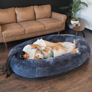 Woman and dog laying in Plufl Human Dog Bed.