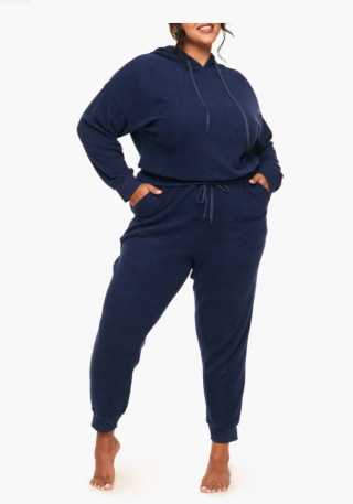 Girl wearing blue sweatpants on white background