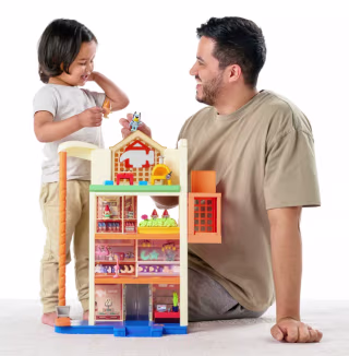 Dad and child playing with Bluey Hammerbarn playset.
