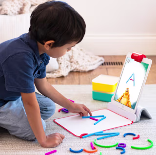 Child playing with Osmo Little Genius Starter Set.