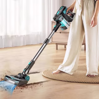 Cordless vacuum cleaner cleaning up dirt on a hardwood floor