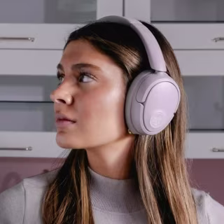Woman wearing mauve over-ear headphones