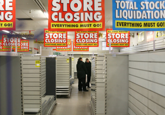 Empty shelves are pictured in a branch of Woolworths in Loughton, east of London, on January 5. Britain's remaining 200 Woolworths stores closed earlier this month.