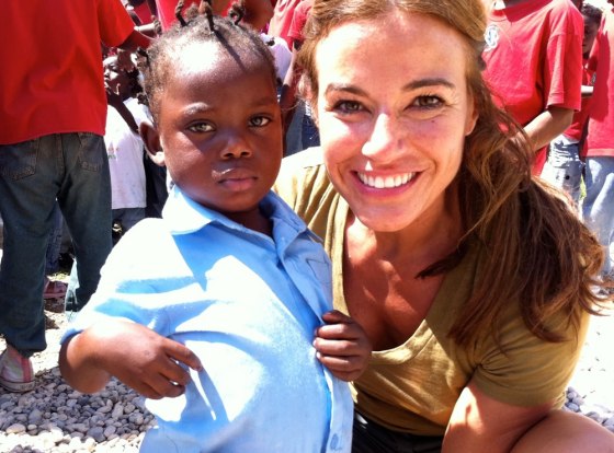 Kelly Bensimon with one of the children at Orphelinat bon Samaritain (The Good Samaritan Orphanage) in Haiti where she helped fund a clean water well through Generosity Water.