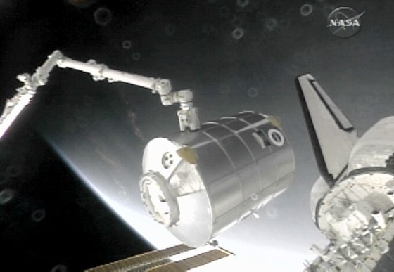 Image: The International Space Station's robotic arm removes the Leonardo Multi Purpose Logistics Module