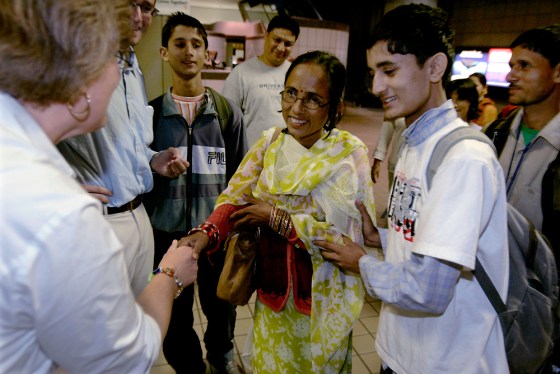 Chitra Gautam, 19, right, introduces his mother, Jamuna Gautam, 36, center, to Catholic Charities representative Clare Kushman, left, as his father Dina Gautam, 40, stands behind him after their arrival at the Greater Pittsburgh International Airport in Imperial, Pa., Monday, Sept. 22. 