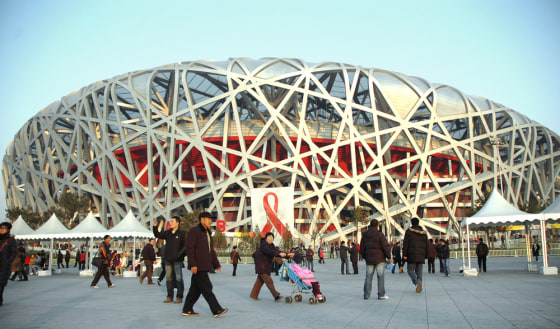 Image: Chinese visitors walk pass the National Olympic Stadium
