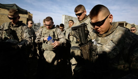 Image: U.S. Army soldierspray before heading out on patrol in Baqouba.
