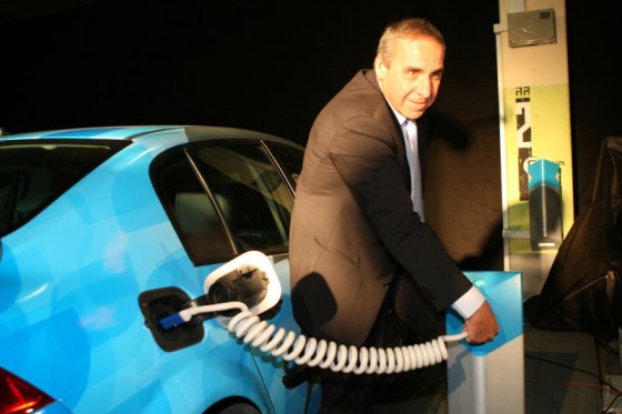 Better Place Israel CEO Moshe Kaplinsky plugs into an electric vehicle charging station in Tel Aviv on Monday.