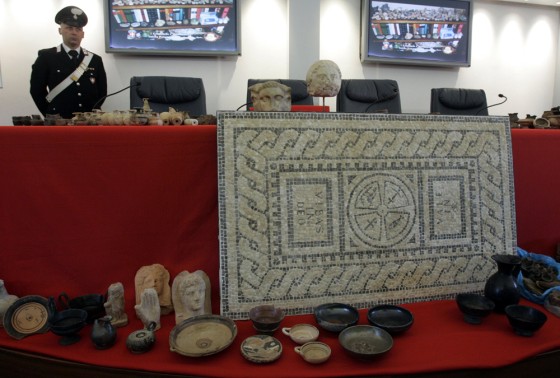 Image: An Italian Carabinieri paramilitary officer stands by artifacts