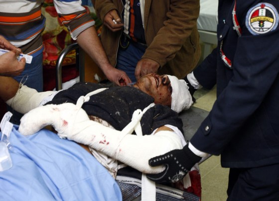 Image: A traffic policeman who was wounded in a bomb attack lies in a hospital in Baghdad
