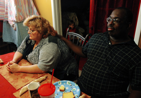 Image: Darrell West (right) comforts his girlfriend Vickie Lewis Dunham
