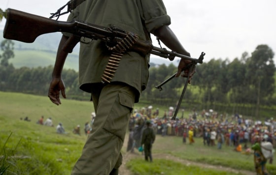 Image: An FDLR soldier walks toward a distribution center near Lushubere Camp in Masisi in the DRC