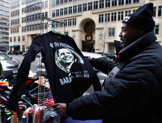 Image: Cornelius Williams, of Washington holds a T-shirt with the image of President-elect Barack Obama on it.