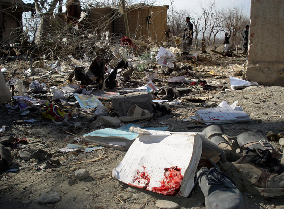 Image: School textbooks and shoes are seen on the ground after a suicide attack in Khost province