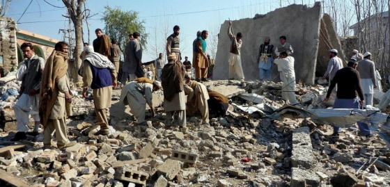 Image: Local residents gather at the site of a suicide bombing in Buner, a district bordering Swat Valley, Pakistan