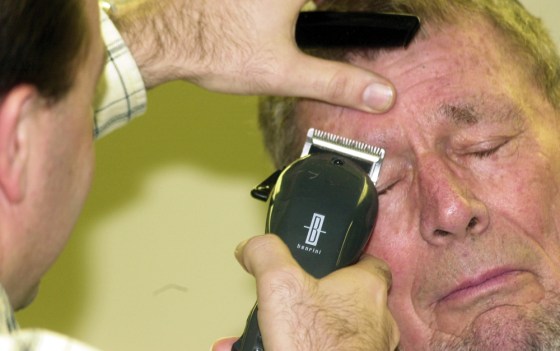 A Bloomfield Rotary Club member shaves off part of Si Burgher's eyebrow in Bloomfield, Ind. Tuesday, Jan. 13, 2009 as part of a fundraiser for Rotary International's PolioPlus project.