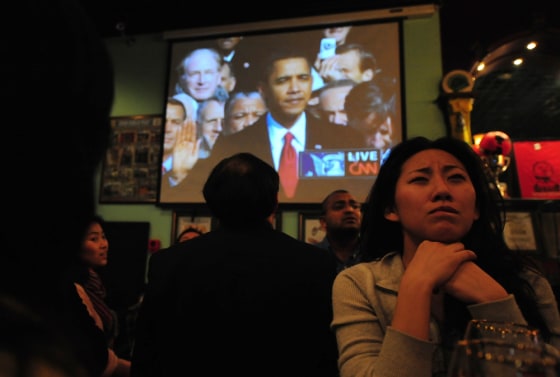 Image: A woman watches the inauguration of US President Barack Obama