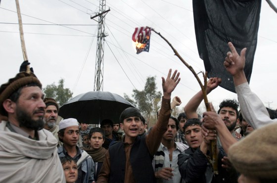 Image: Afghan villagers burn U.S. flag during a protest rally against the U.S. and Afghan governments