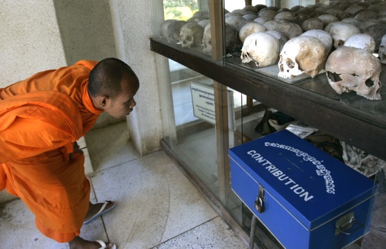 Image: monk looks at skulls