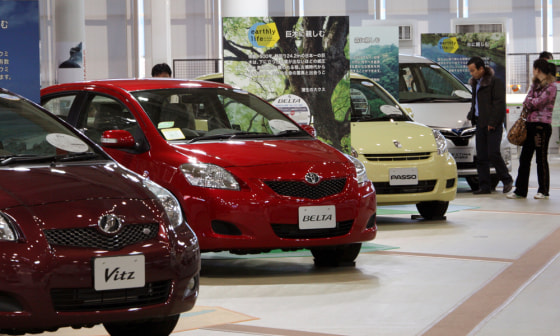 Image: Visitors look at the models of Toyota Motor Corp. vehicles