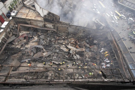 Image: Rescue workers go through the debris at the Nakumatt supermarket in Nairobi
