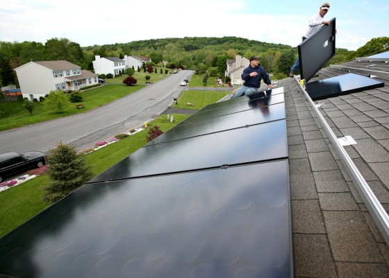 Image: workmen install solar panels
