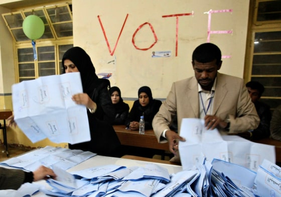Iraqi electoral workers empty ballot boxes at the end of a day of voting in provincial elections in the southern city of Basra on Saturday. Voting in Iraq's provincial elections began amid tight security in the nation's first ballot since 2005.