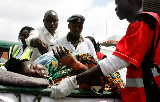 Image: A woman burnt after an oil truck crashed and burst into fire vomits at the Wilson airport in Nairobi