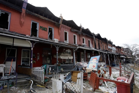 Broken windows and stains from smoke are seen in the aftermath of a January fire that damaged or destroyed a row of 15 homes, in Coatesville, Pa.