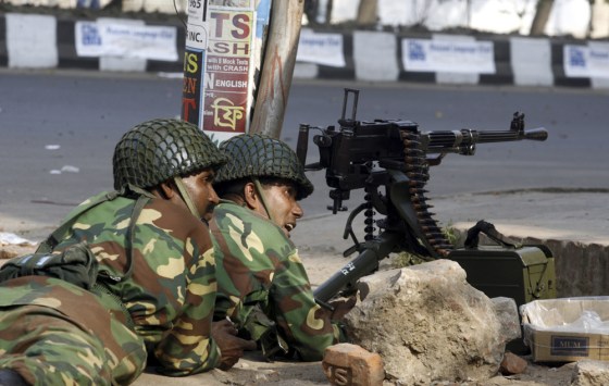 Image: Army soldiers take their positions on a street near the headquarters of the paramilitary Bangladesh Rifles in Dhaka