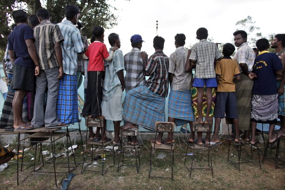 Tamil people chat with their relatives over the fence of a temporary refugee camp in Vavuniya, northern Sri Lanka